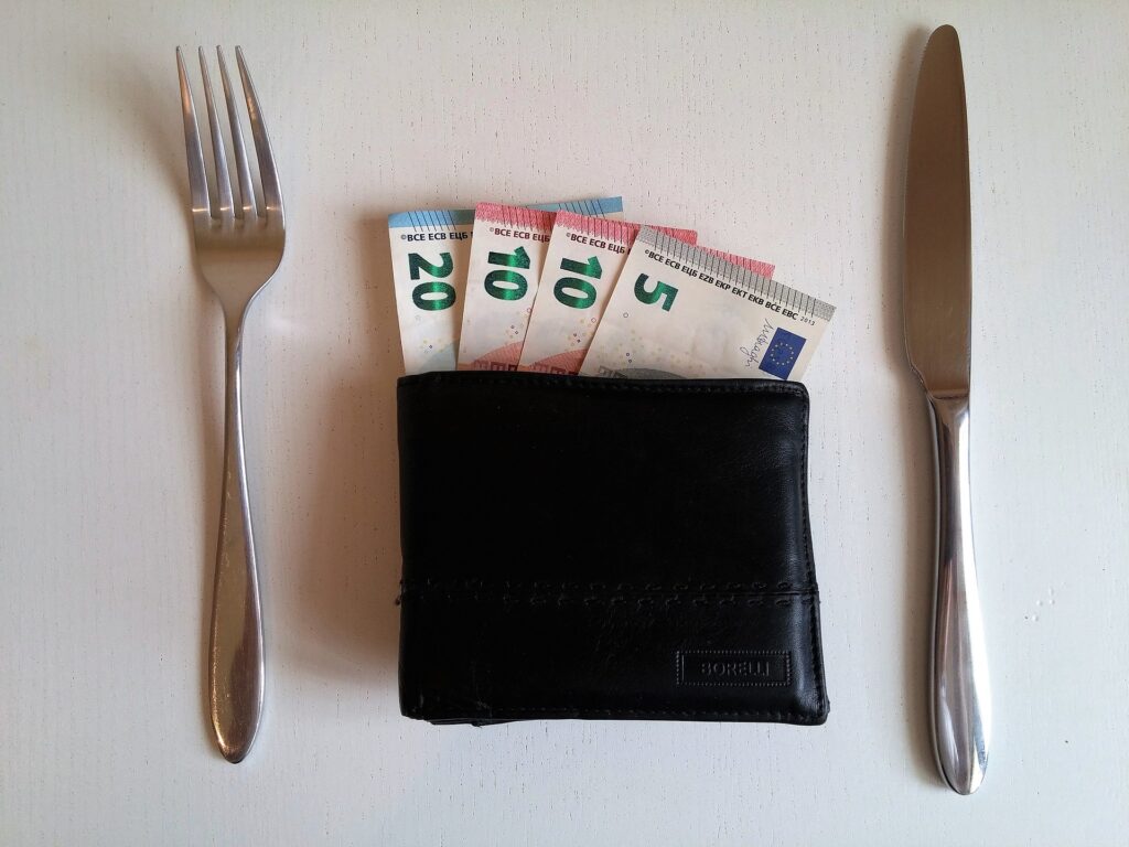 wallet with money at dinner table