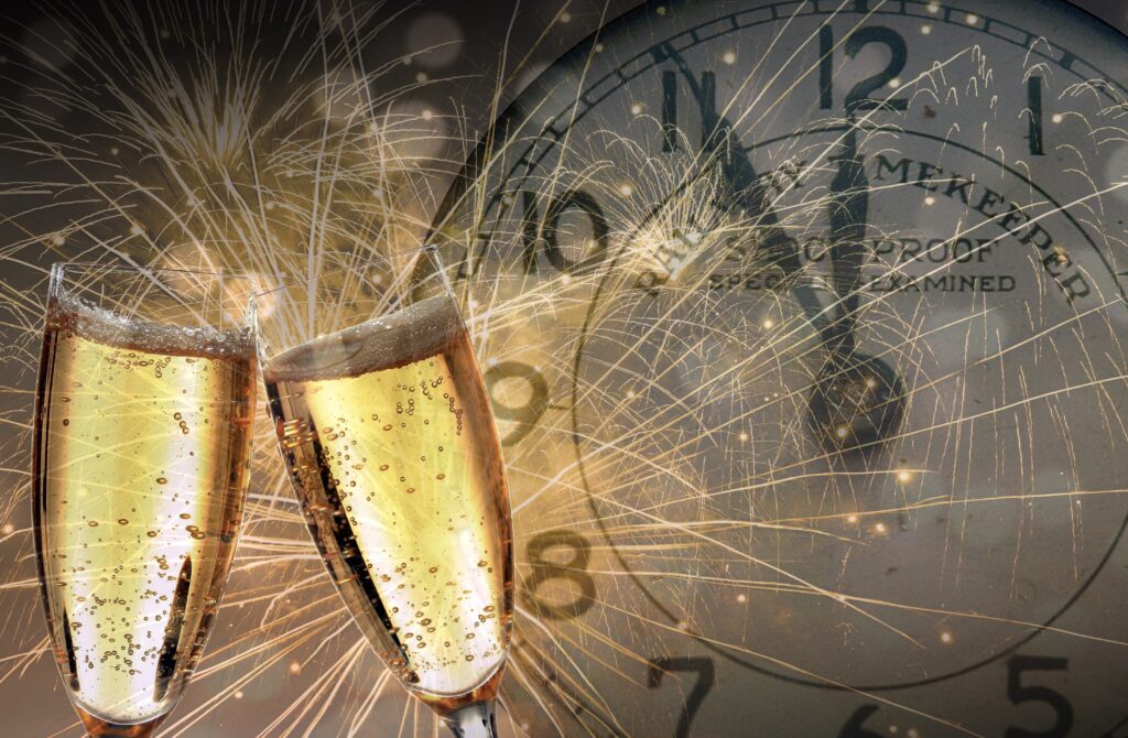 champagne glasses and clock striking midnight